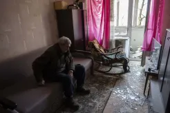 Volodymyr, 80, rests inside his apartment